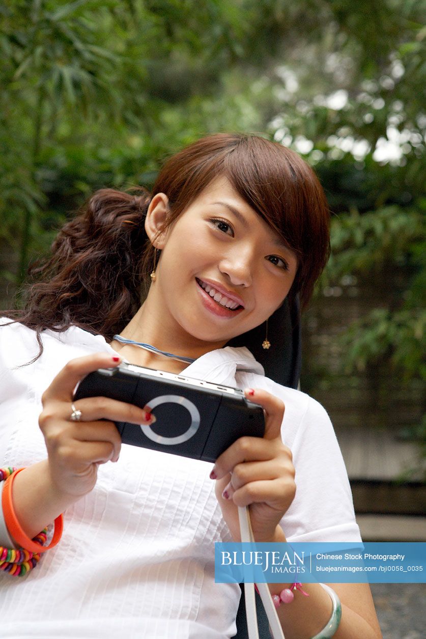 Chinese woman looking at digital camera
