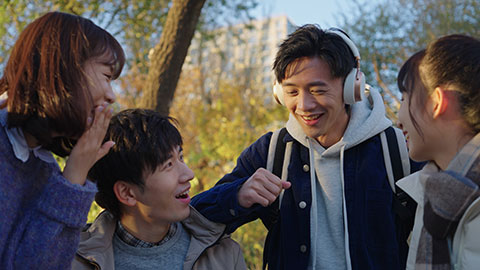 Happy Chinese college students listening to music