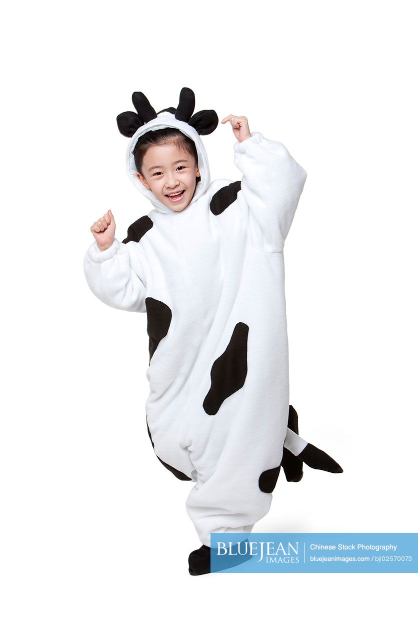 Cute Chinese girl in a cow costume playing