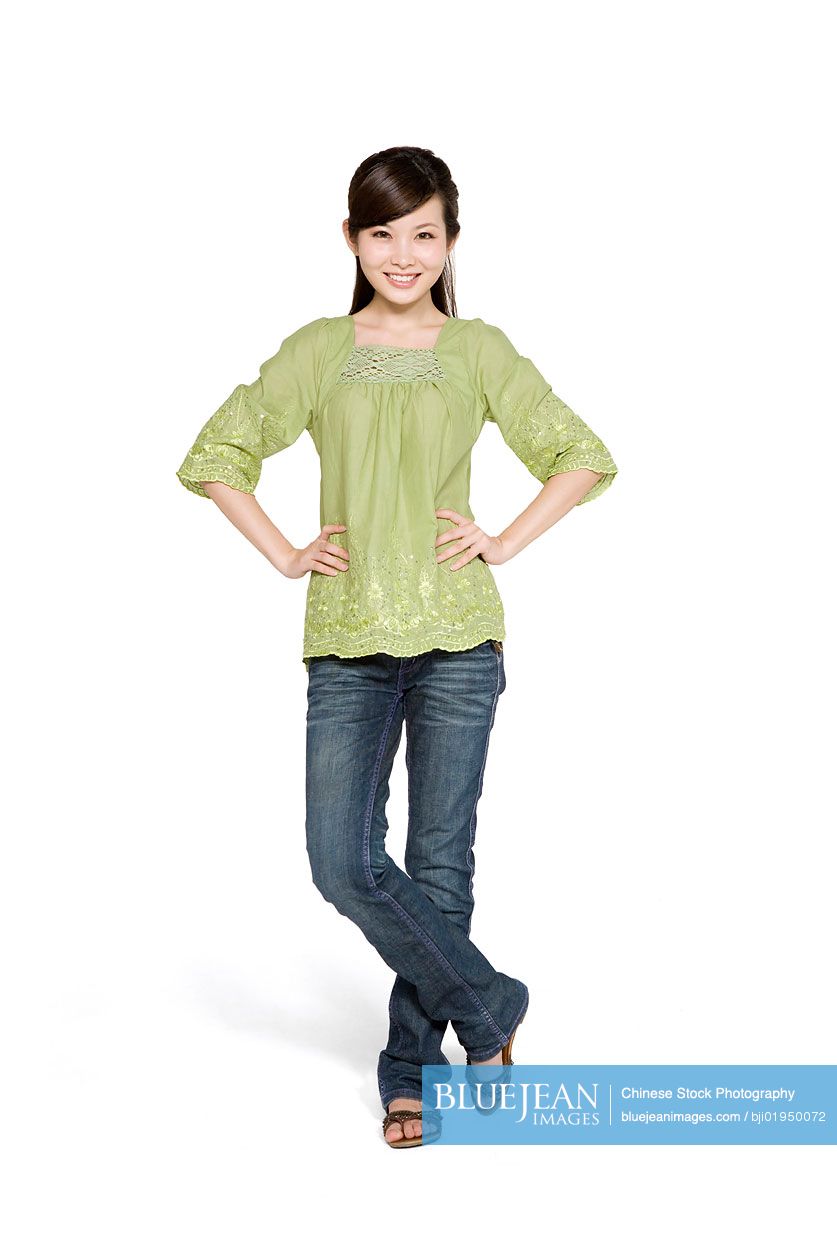 Portrait of young Chinese woman with hands on hips