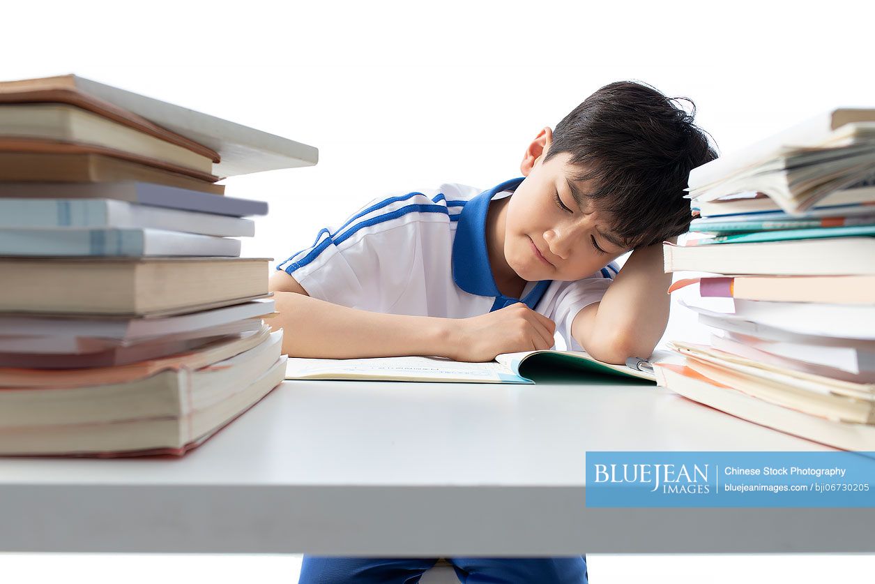 Chinese teenage boy doing homework