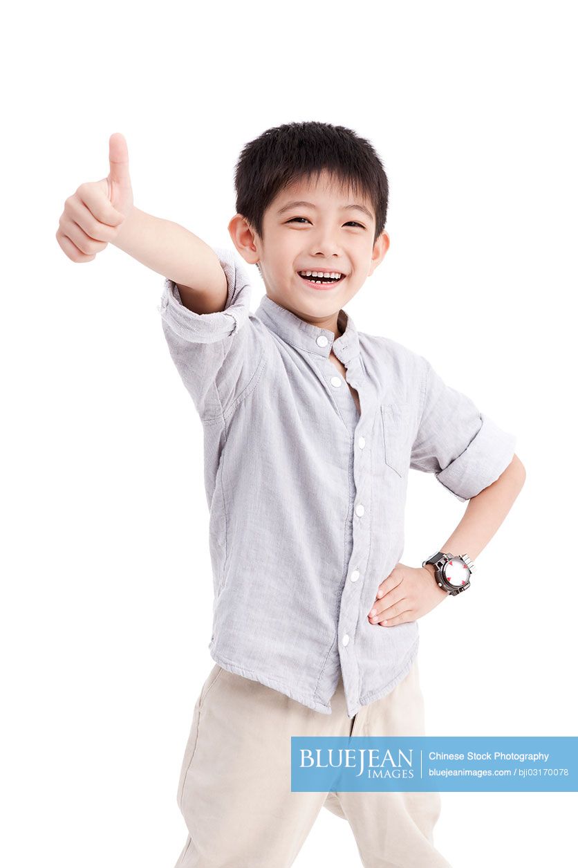 Portrait of cute Chinese boy doing thumbs up