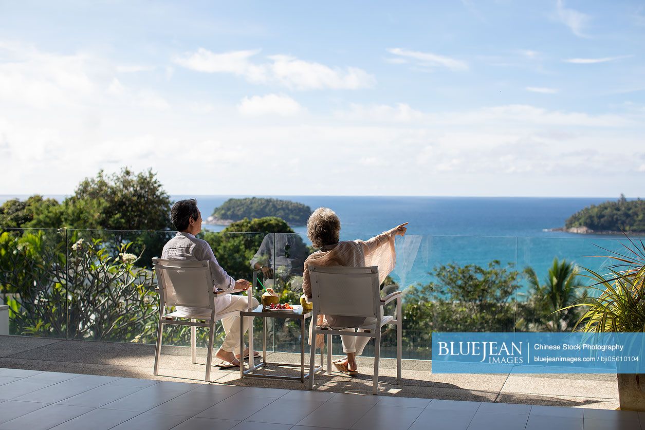 Senior Chinese couple relaxing on balcony