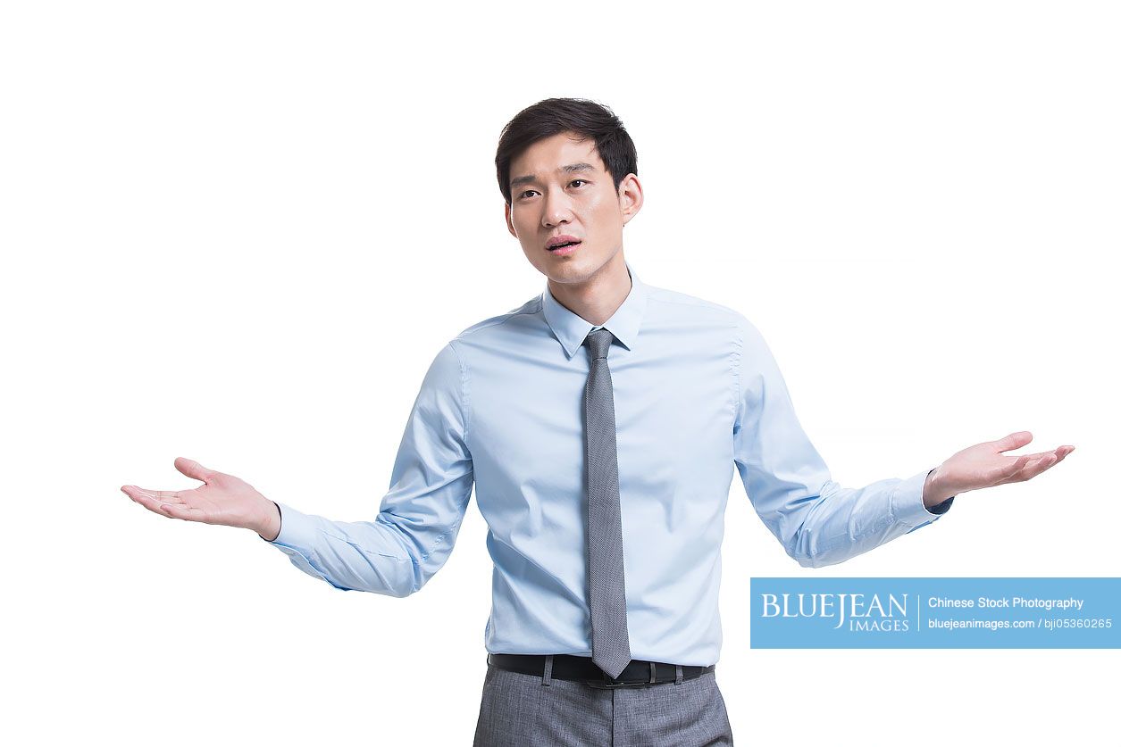 Worried Chinese businessman shrugging