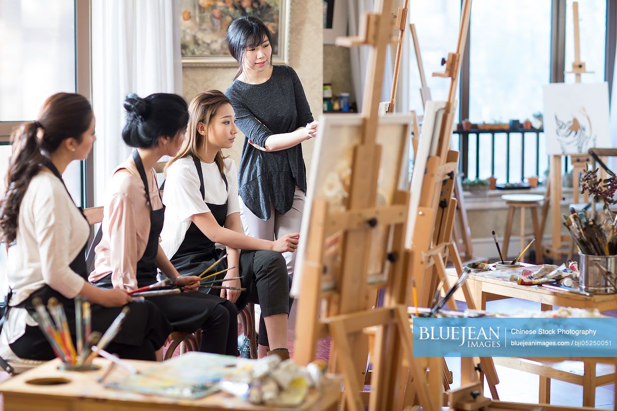 Chinese art teacher with young women in studio