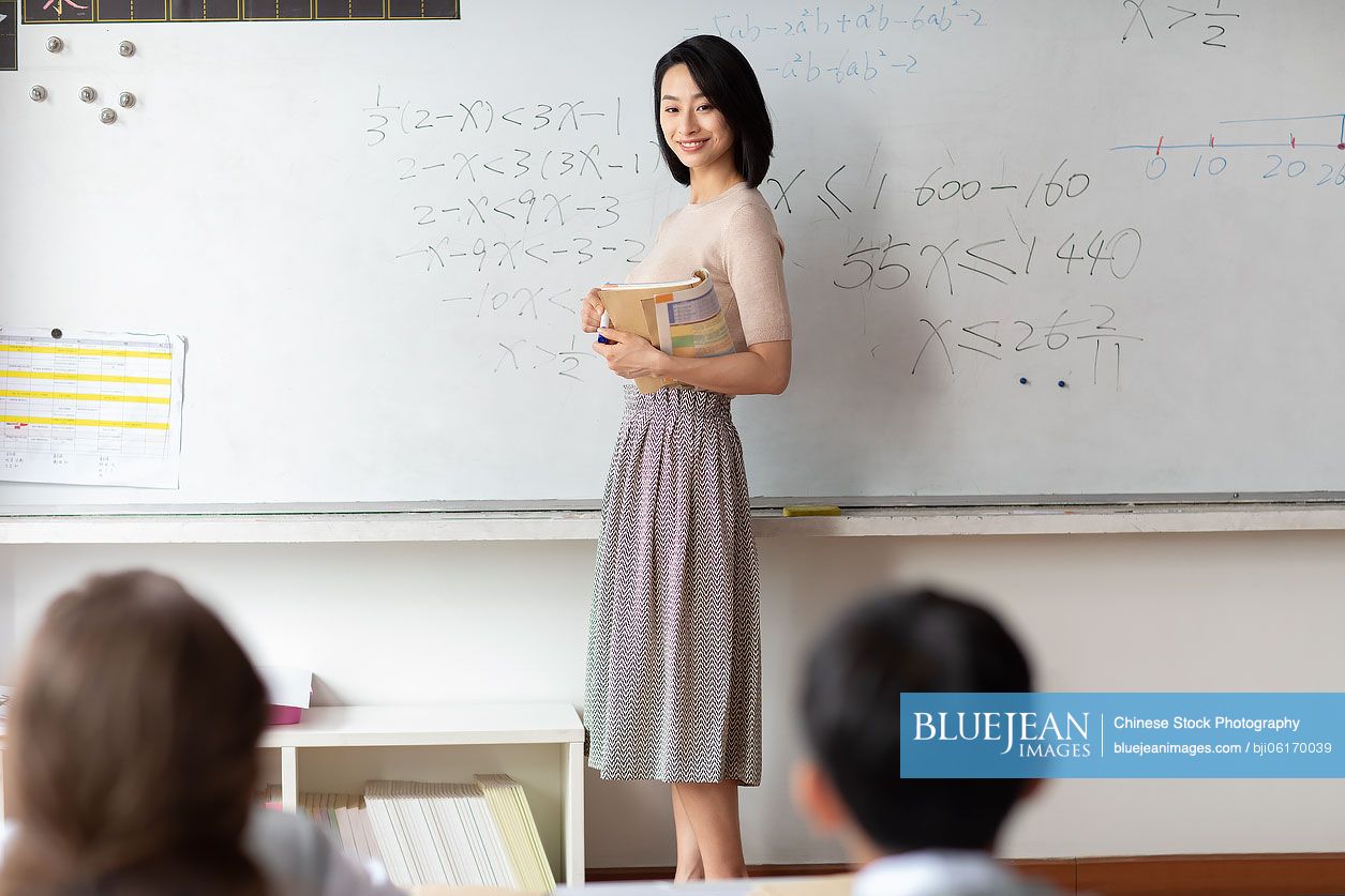 Young Chinese teacher teaching a class
