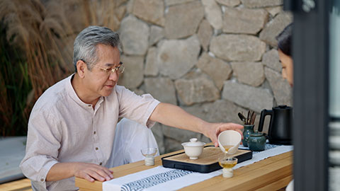 Happy mature Chinese couple drinking tea in tea room,4K