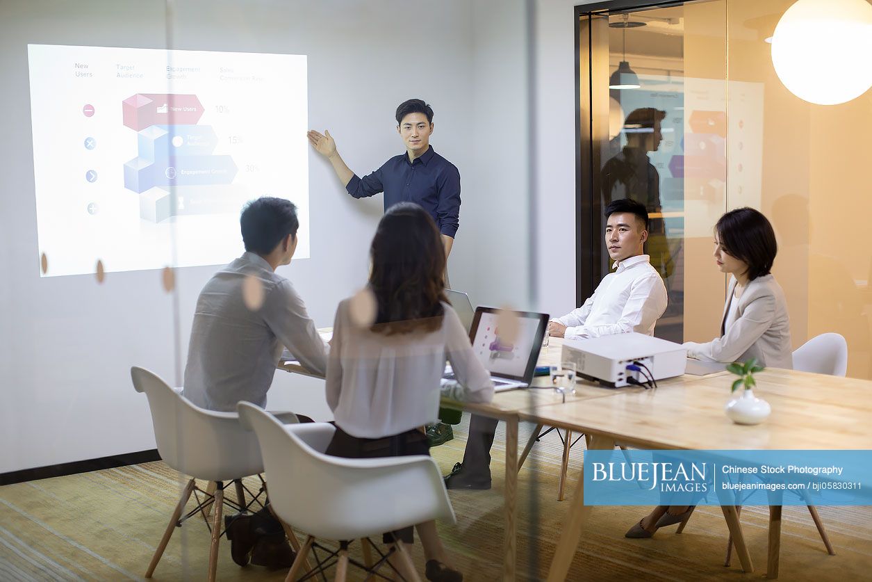 Chinese business people having meeting in board room 