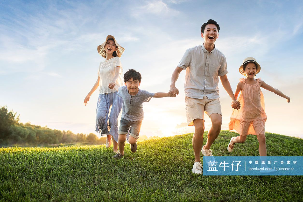 年轻家庭在草地上奔跑