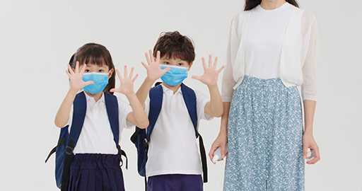 Chinese pupils using hand sanitizer with teacher's help,4K