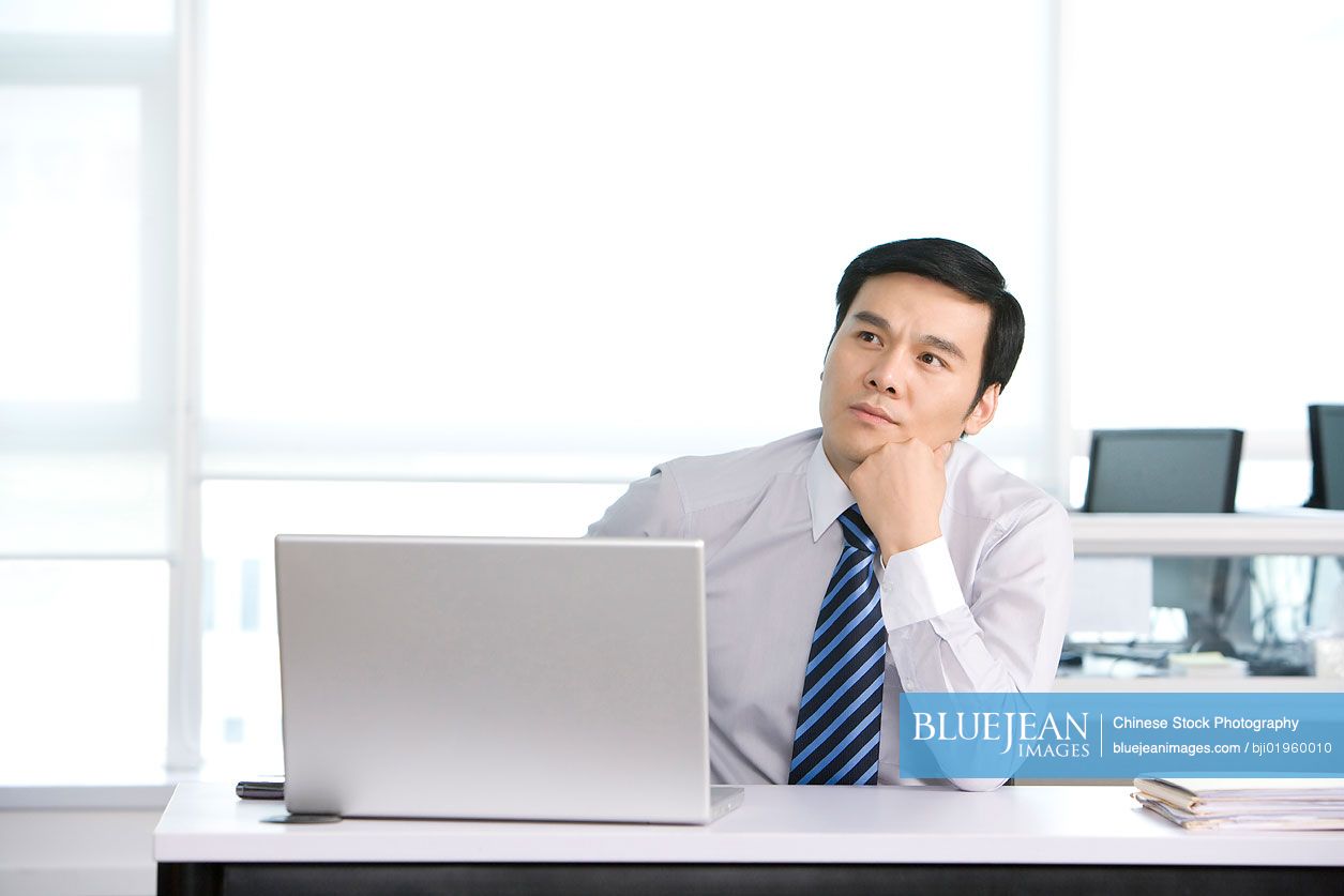 Chinese office worker at his desk