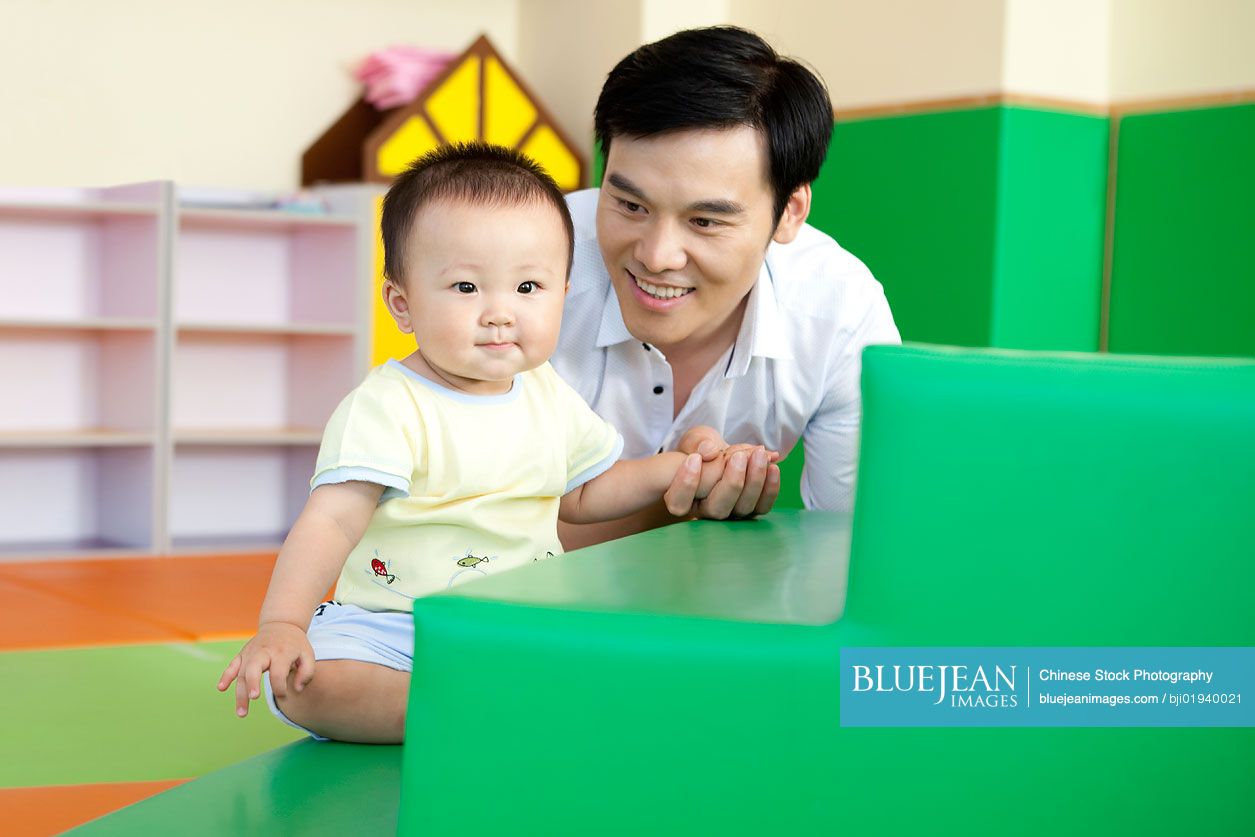 Chinese father playing with son