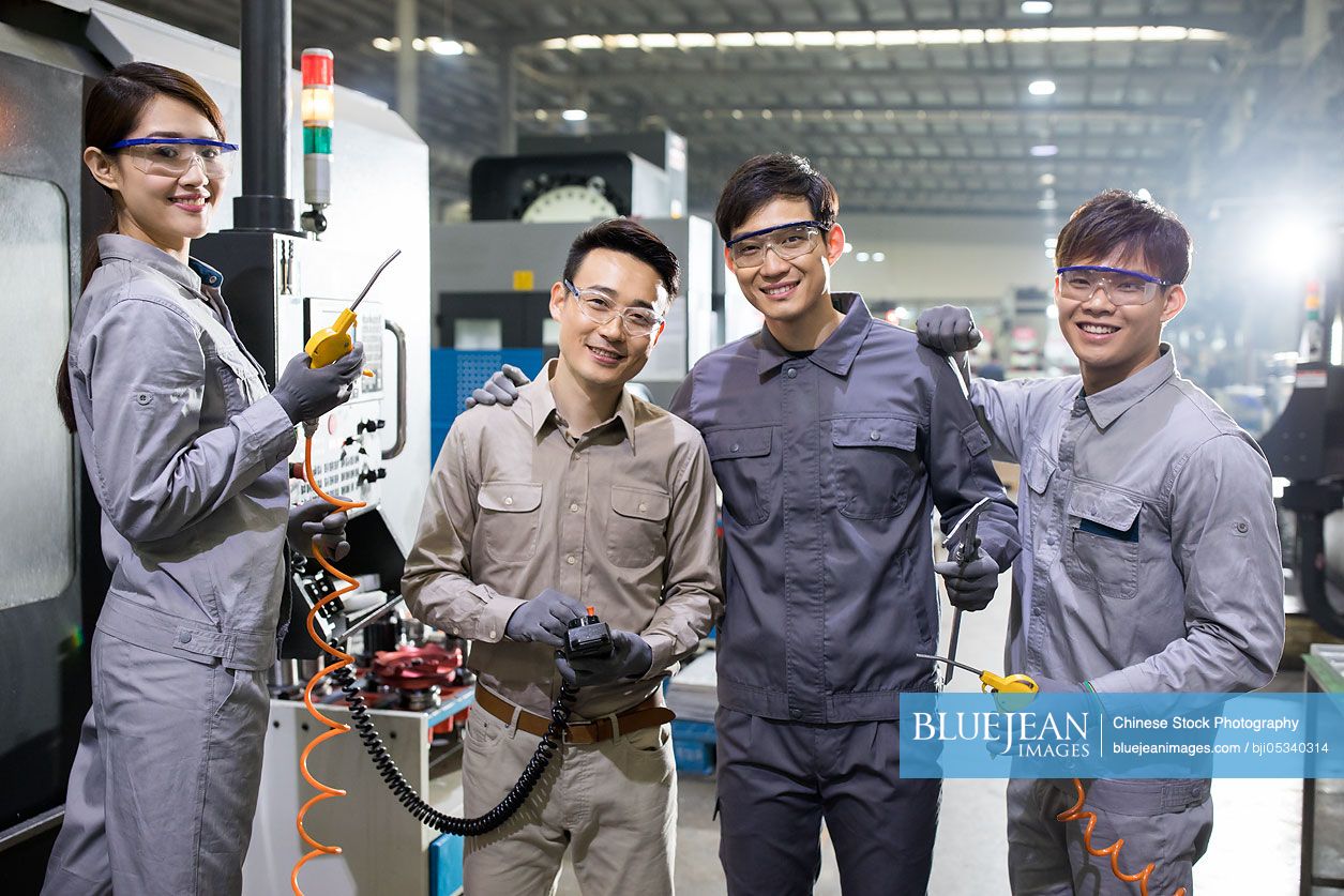 Confident Chinese engineers in the factory