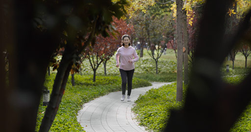 Happy senior Chinese woman running in the park,4K