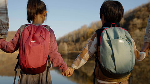 Cheerful young Chinese family enjoying the beautiful natural scenery