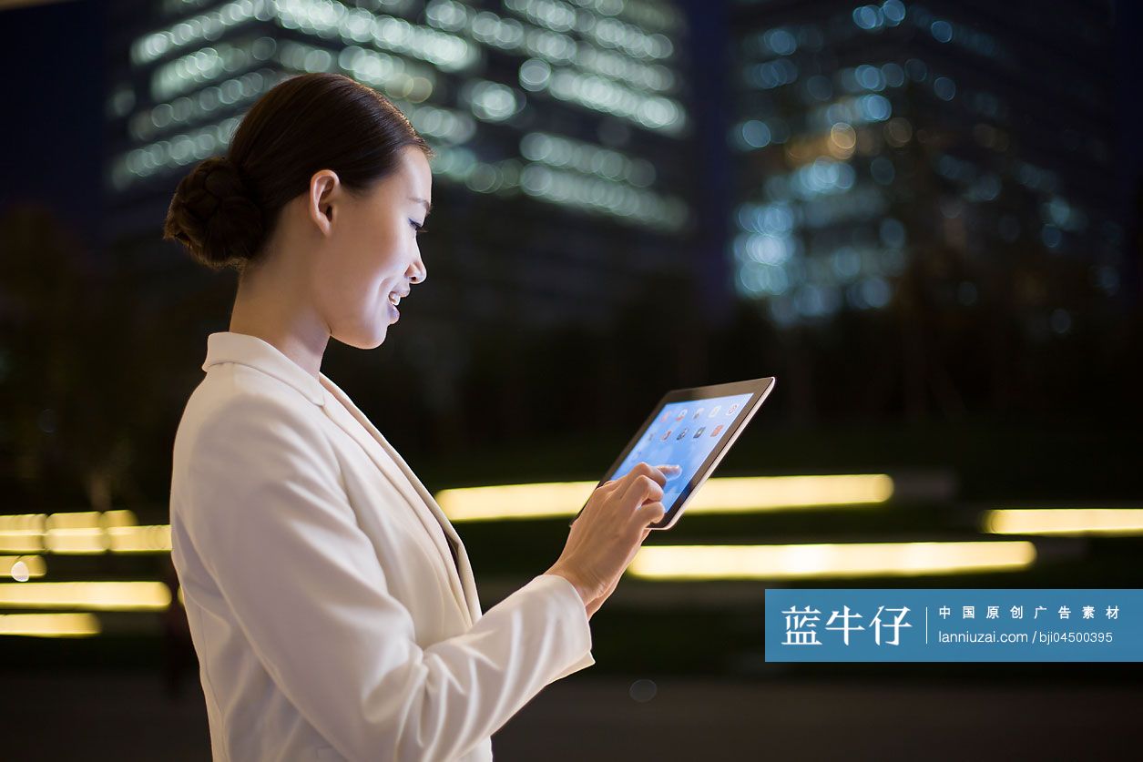 商务女士在户外使用平板电脑