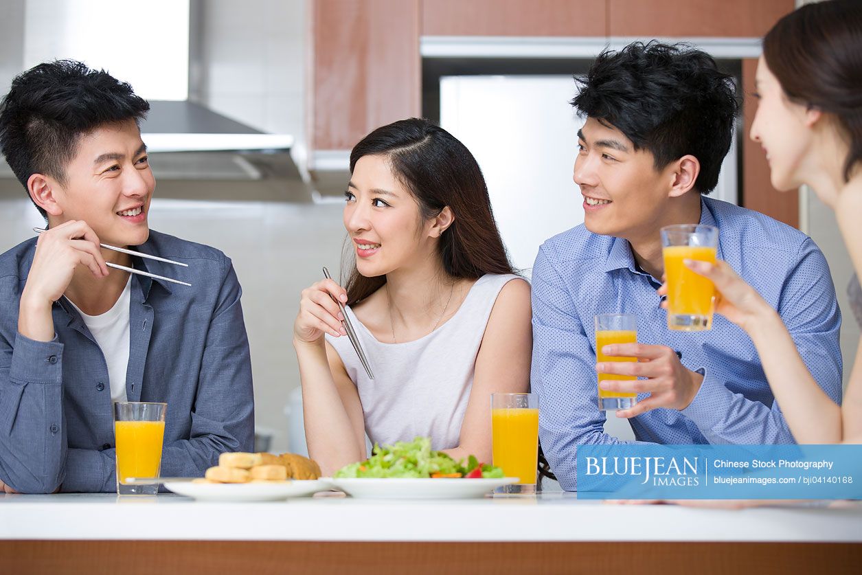 Happy Chinese friends eating together