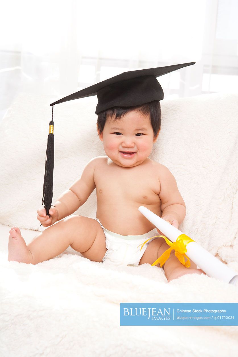 Portrait of a Chinese baby wearing mortar board