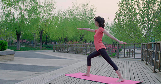 Happy young Chinese woman doing yoga in park,4K