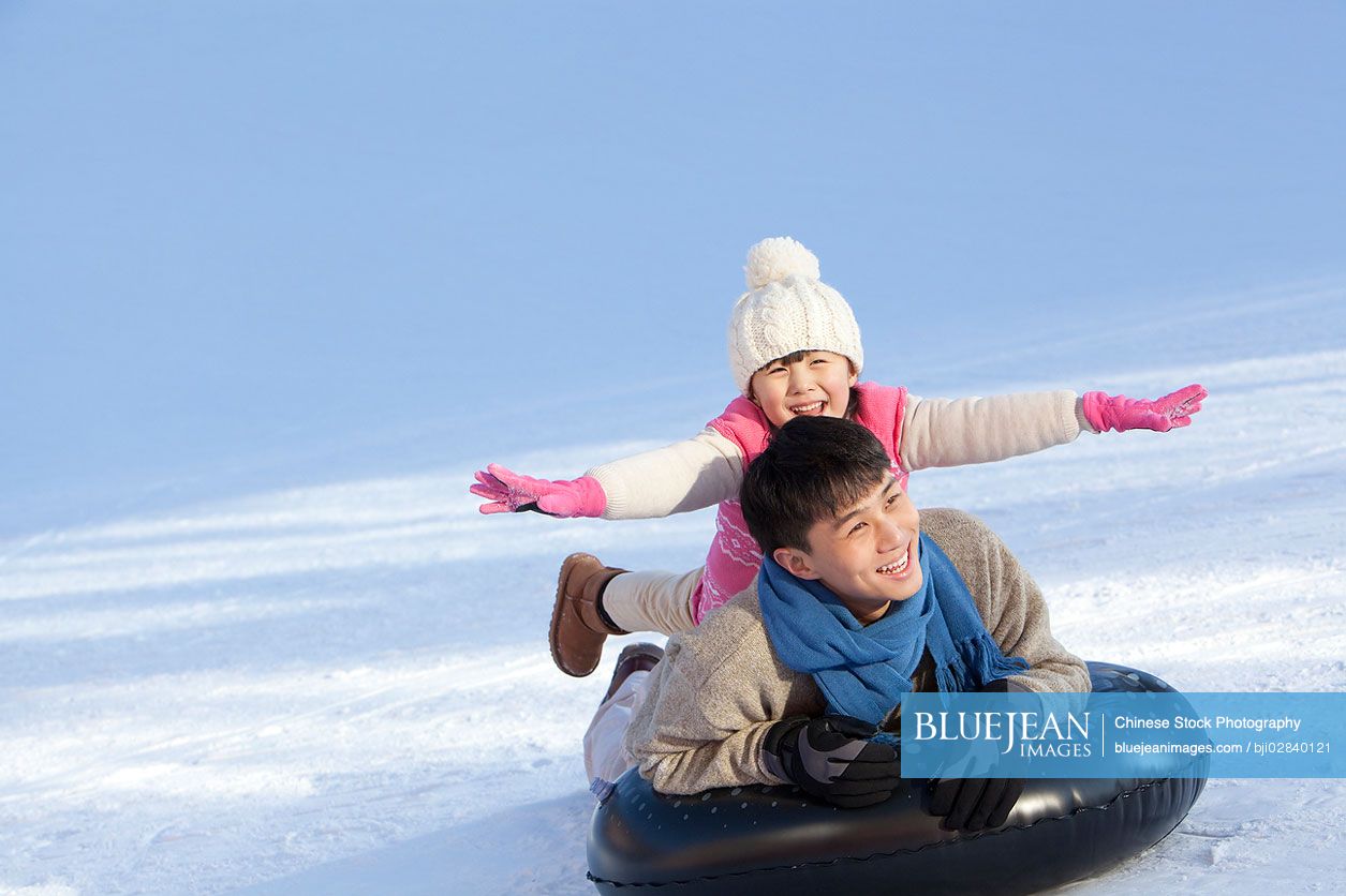 Chinese father and daughter having fun in snow