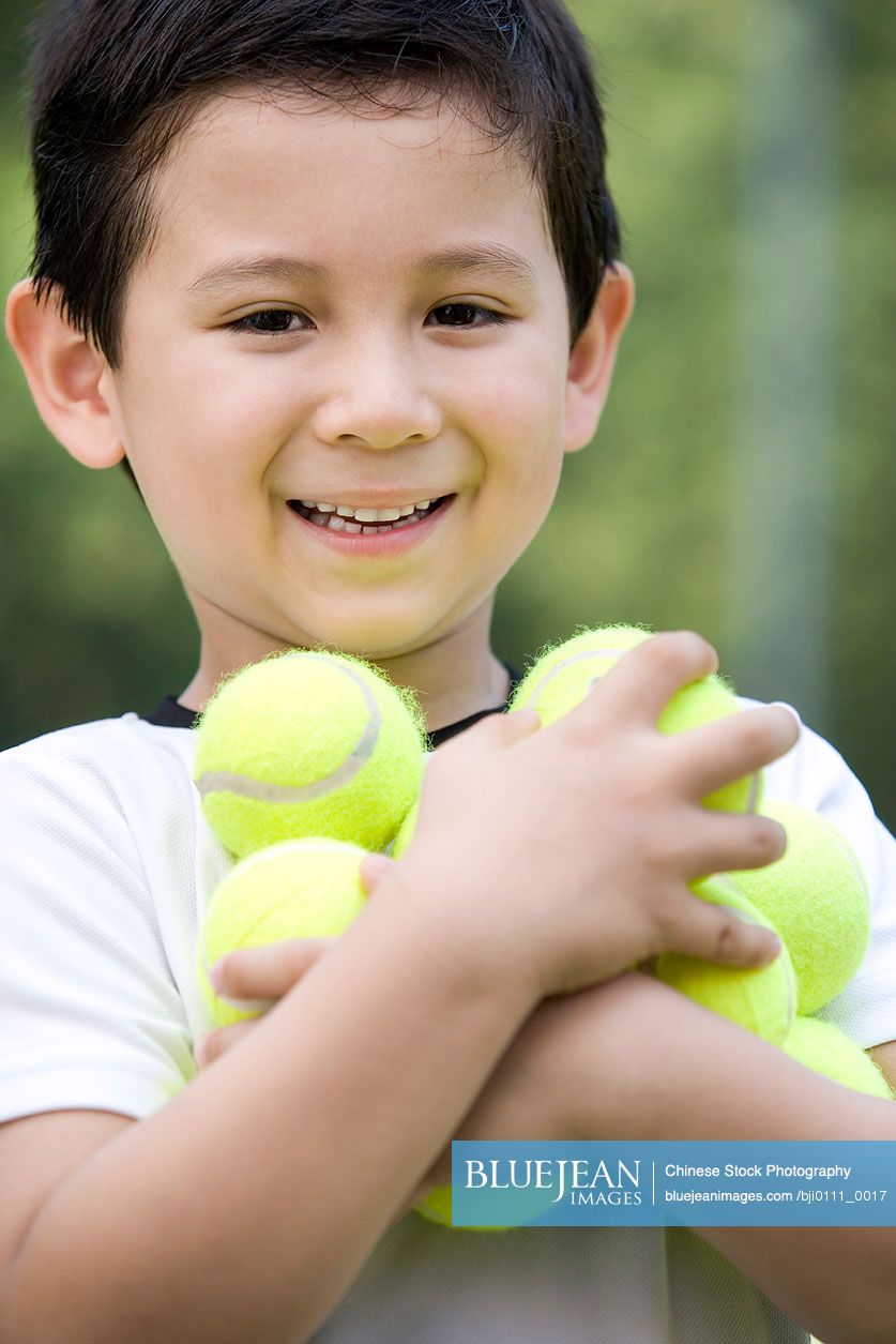 Portrait of a young chinese boy on the tennis court high res stock