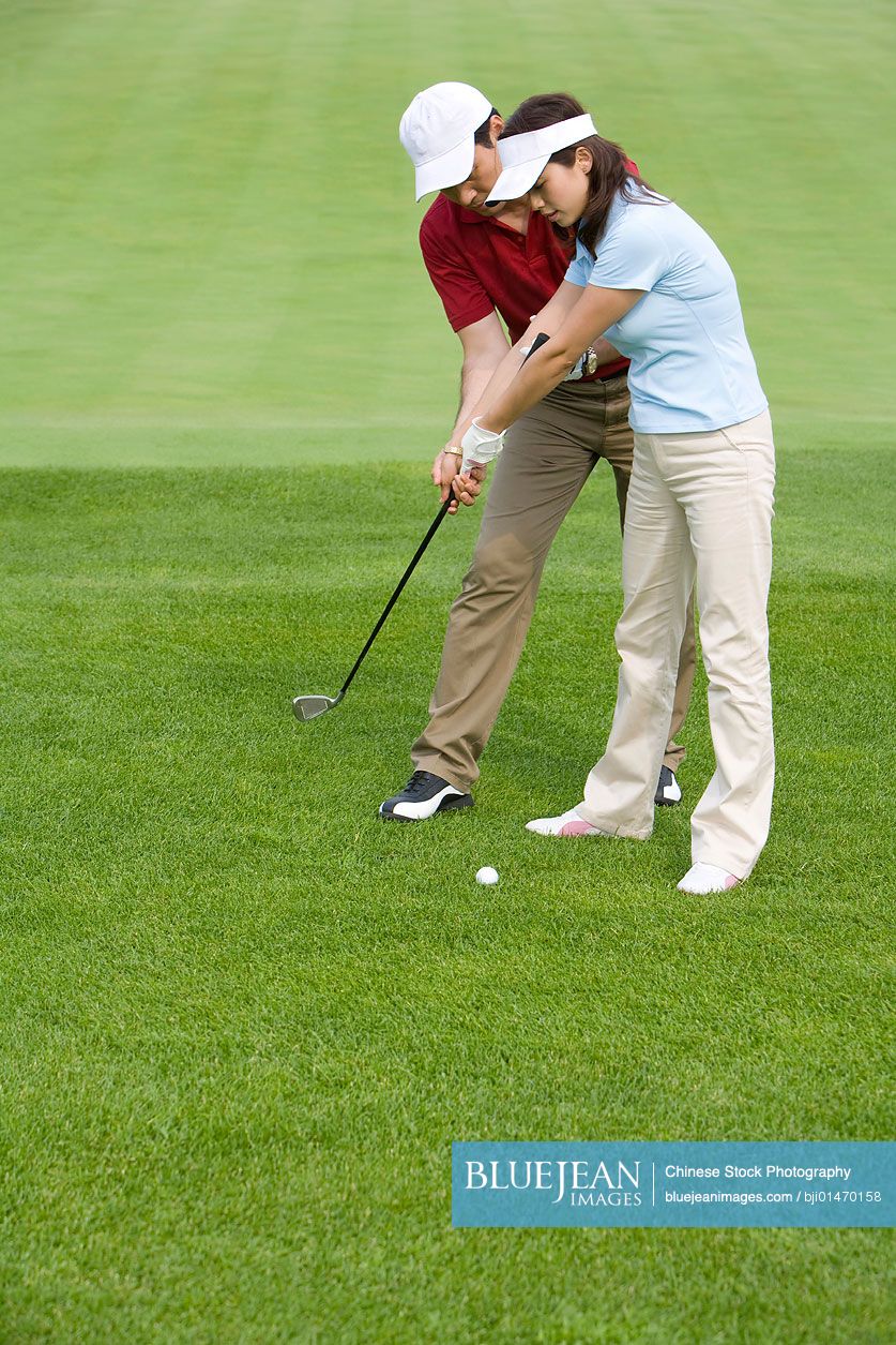 Chinese golf coach teaching golf