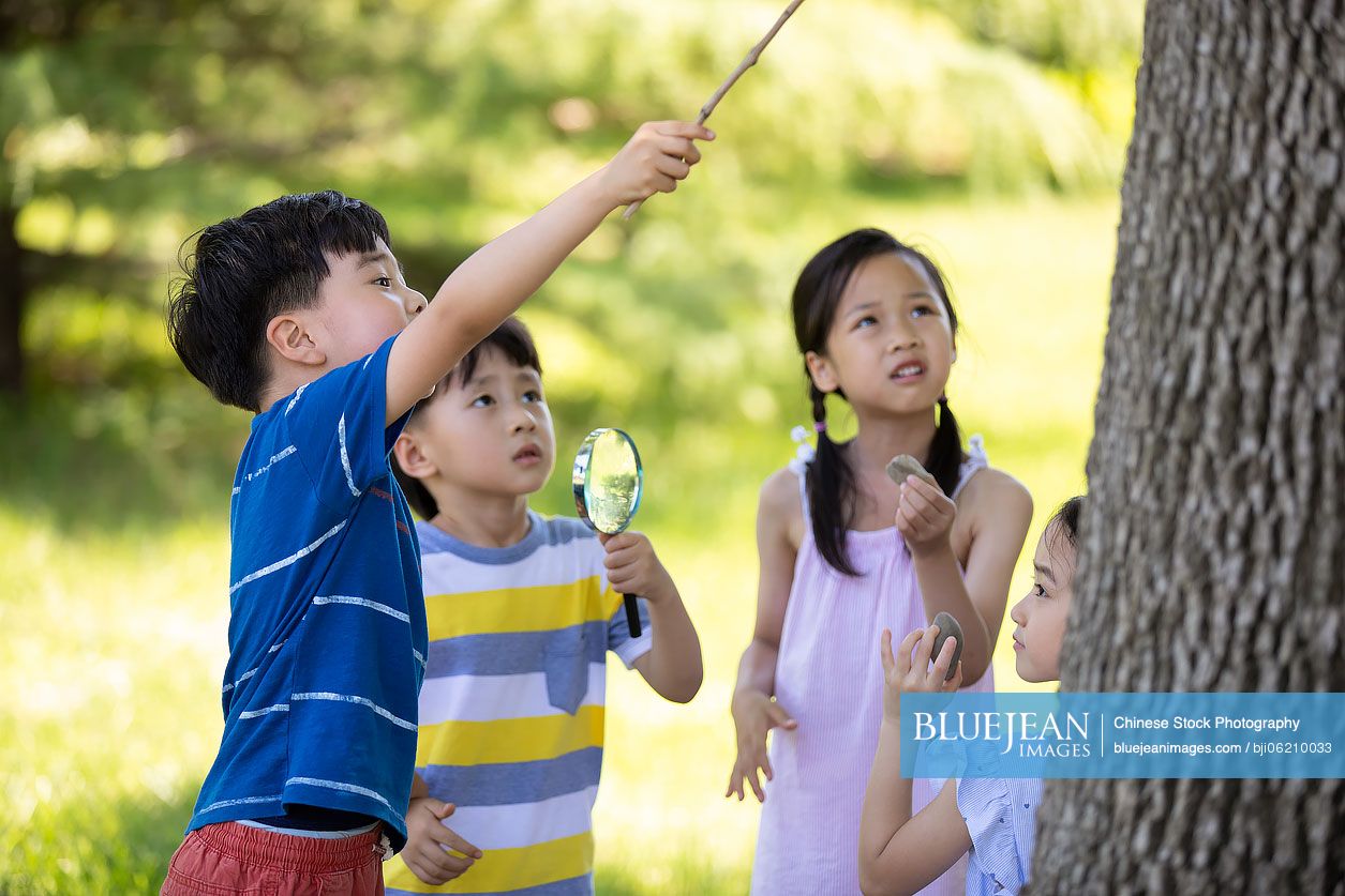 Happy Chinese children playing in park