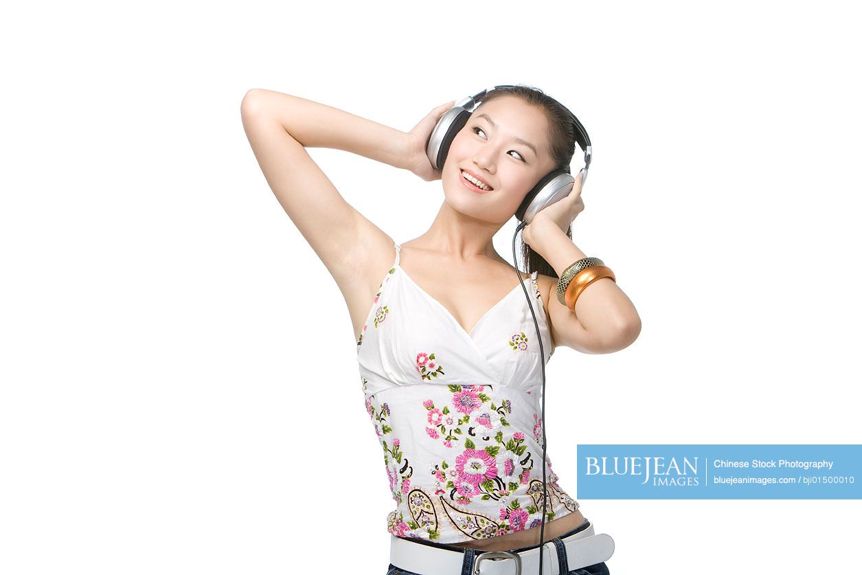 Young Chinese woman with headphones listening to music