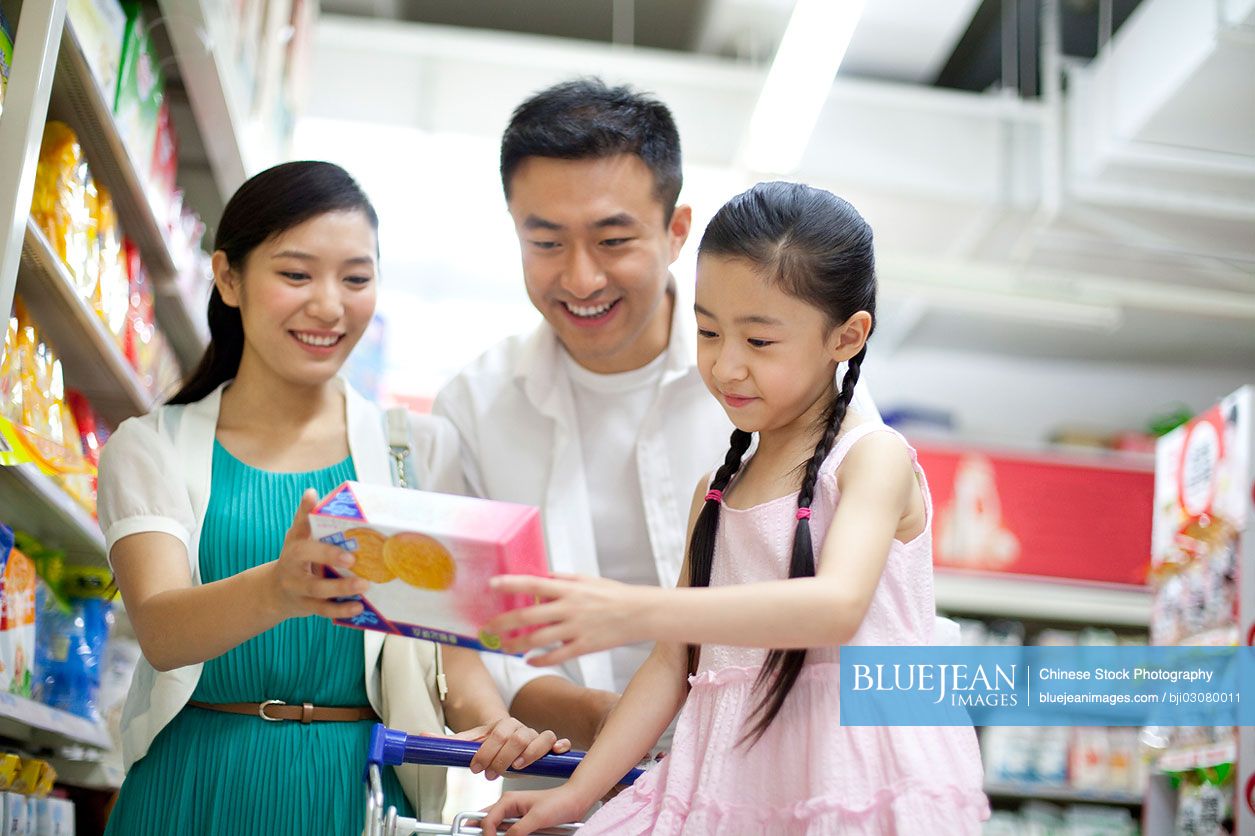 Chinese family shopping in supermarket