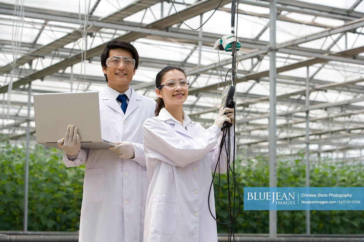 Chinese scientists doing research in modern farm high res stock photo