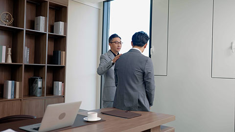 Chinese businessman consoling his colleague