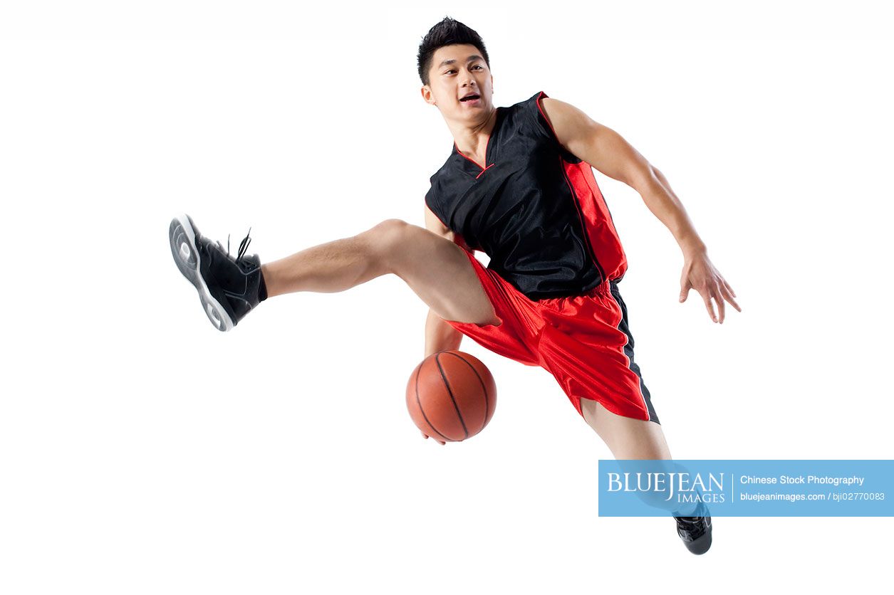 Chinese man jumping doing basketball tricks