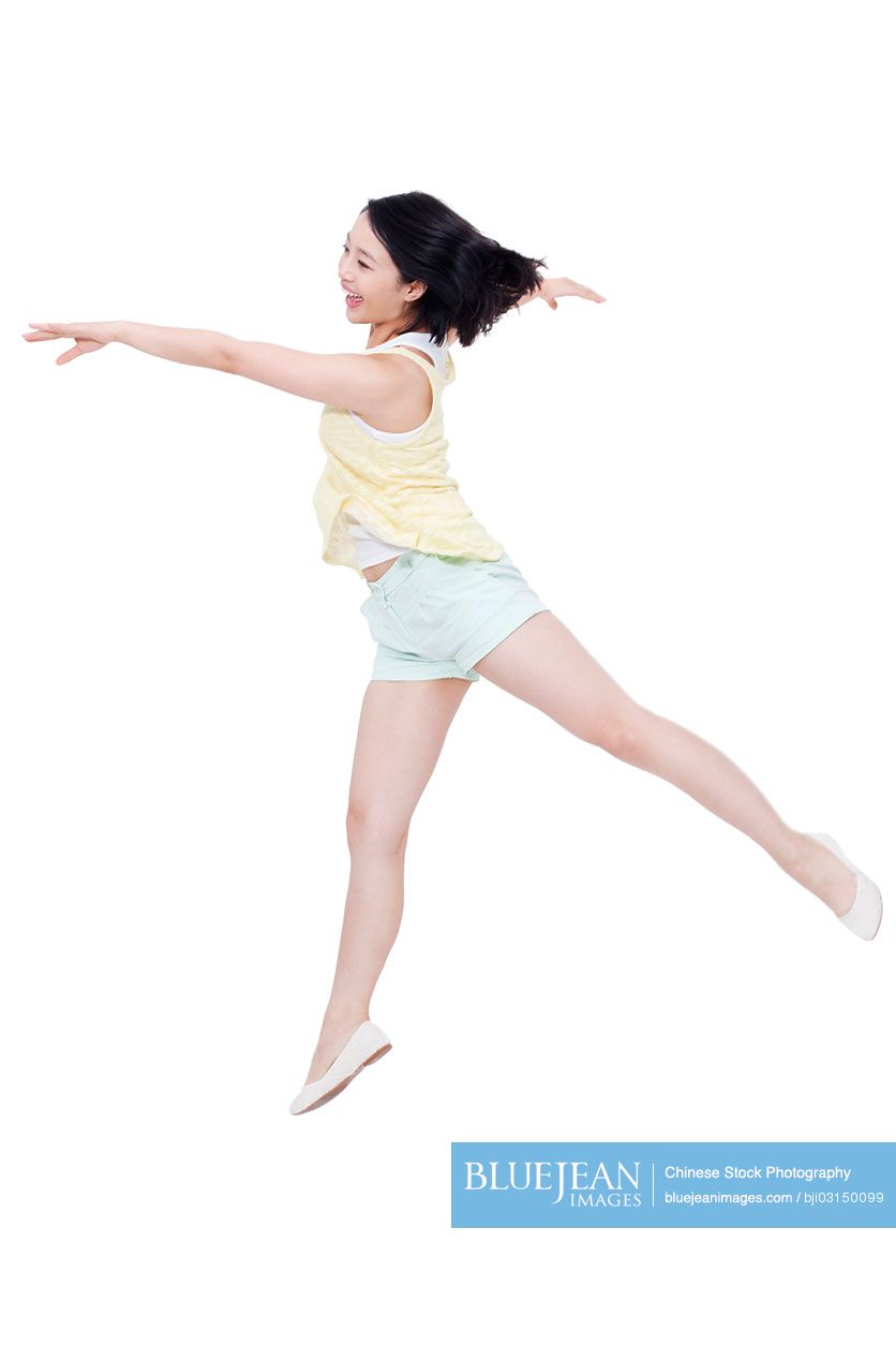 Happy young Chinese woman jumping