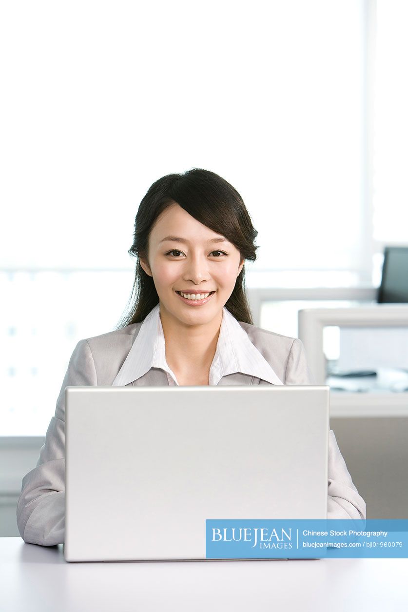 Chinese office worker at her desk