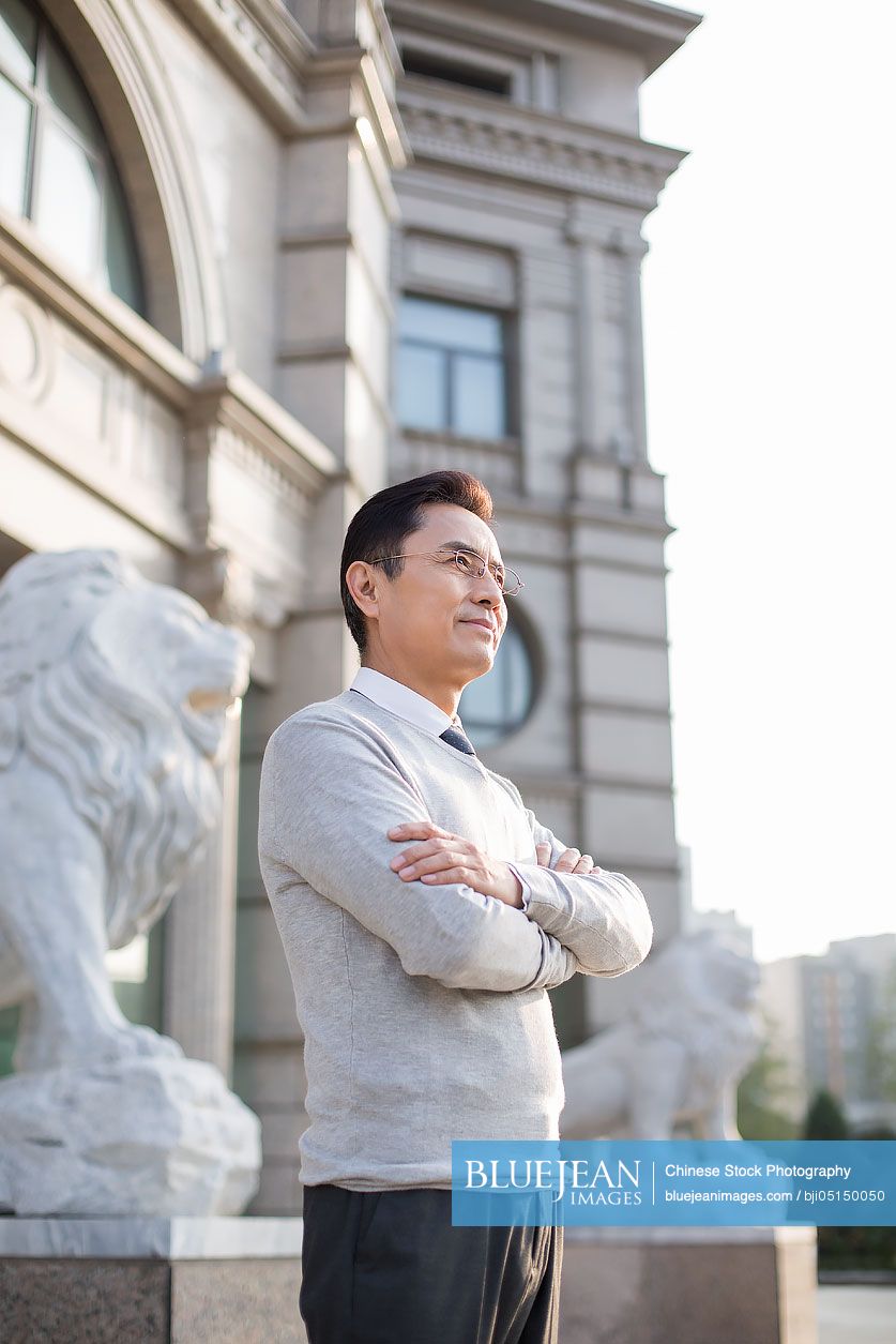 Confident Chinese businessman looking at view