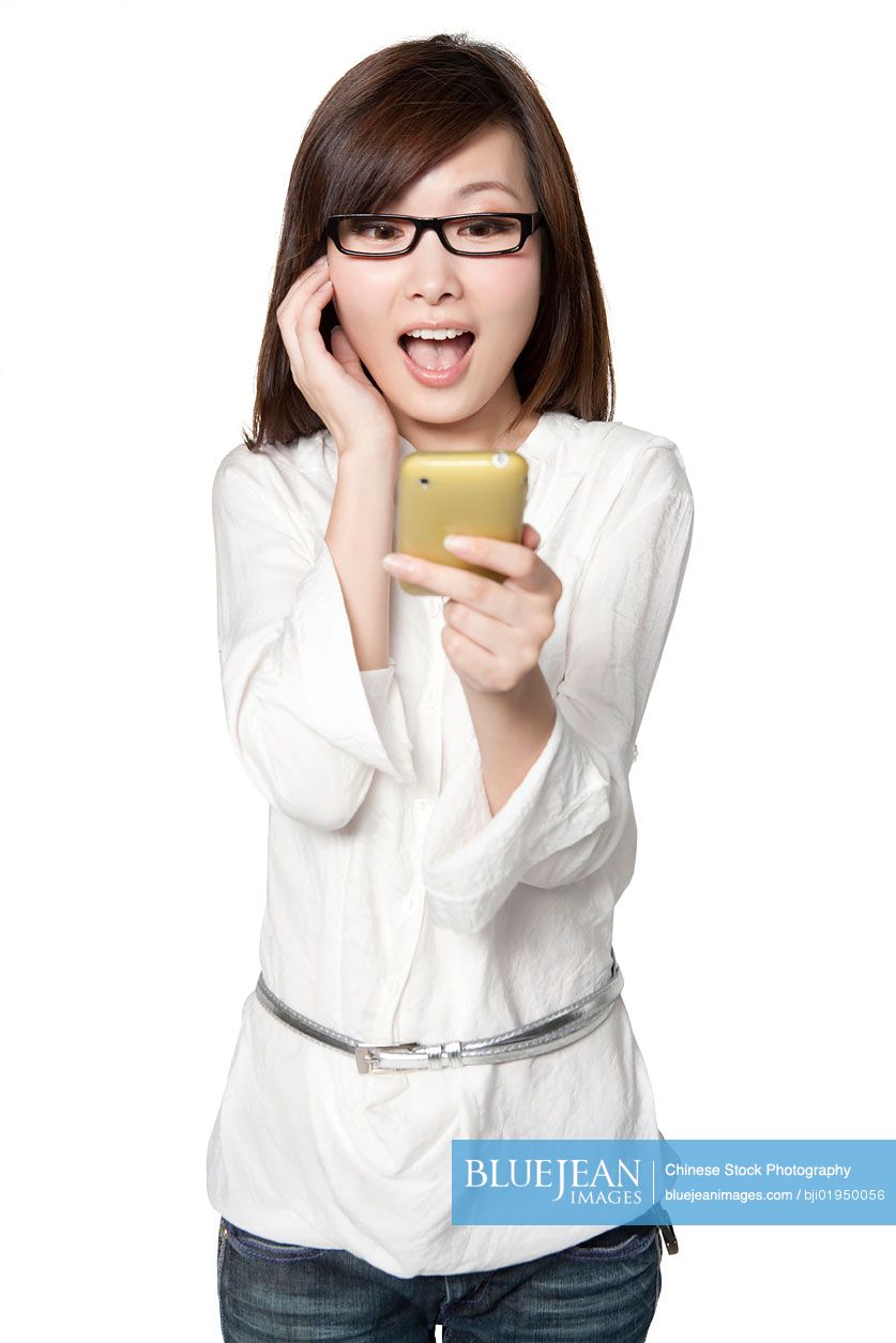 Young Chinese woman surprised by mobile phone