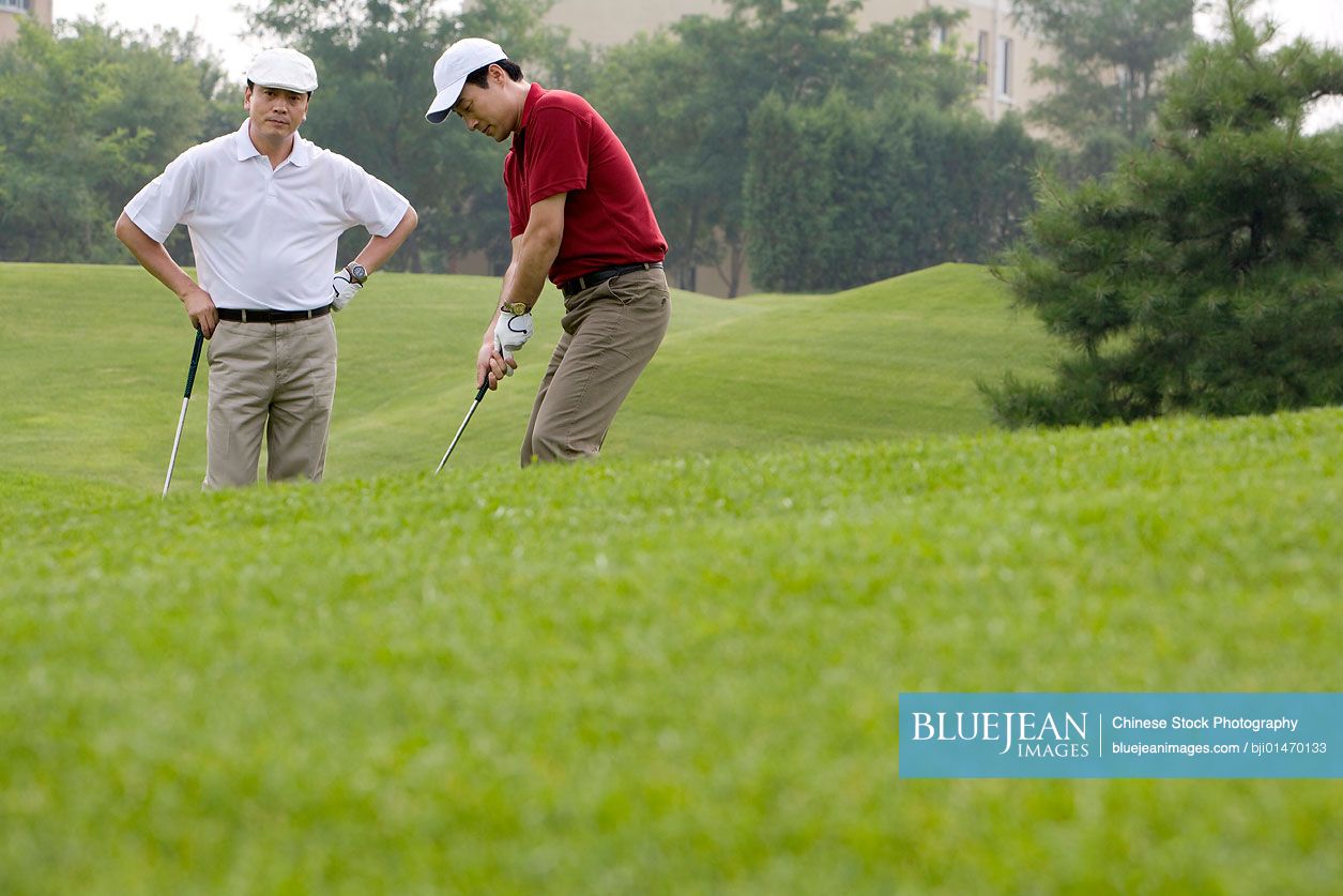 Two Chinese golfers on the course