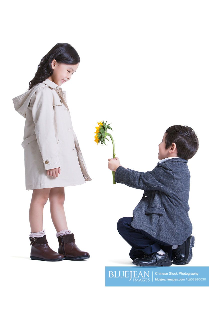Cute little Chinese boy kneeling and proposing to girl-High-res ...