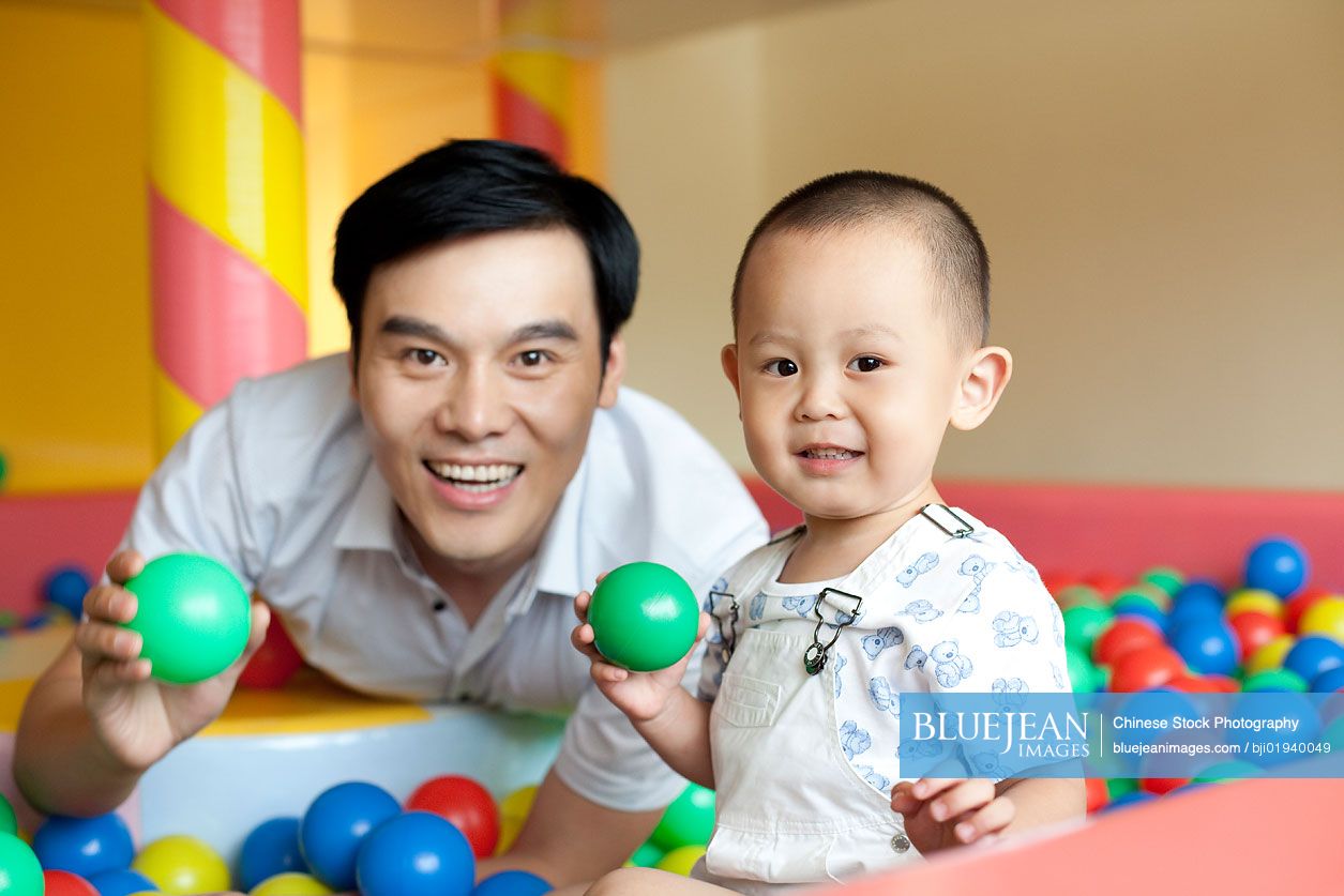 Chinese father playing with son