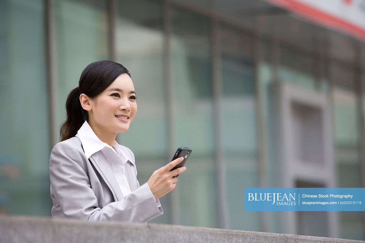 Chinese businesswoman using cell phone