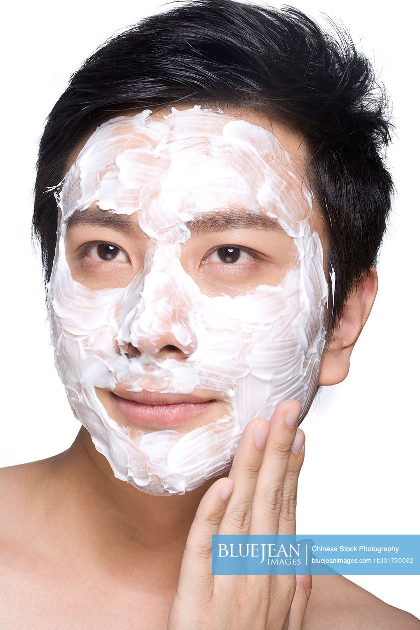 Handsome young Chinese man with facial mask