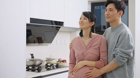 Young pregnant Chinese couple dancing