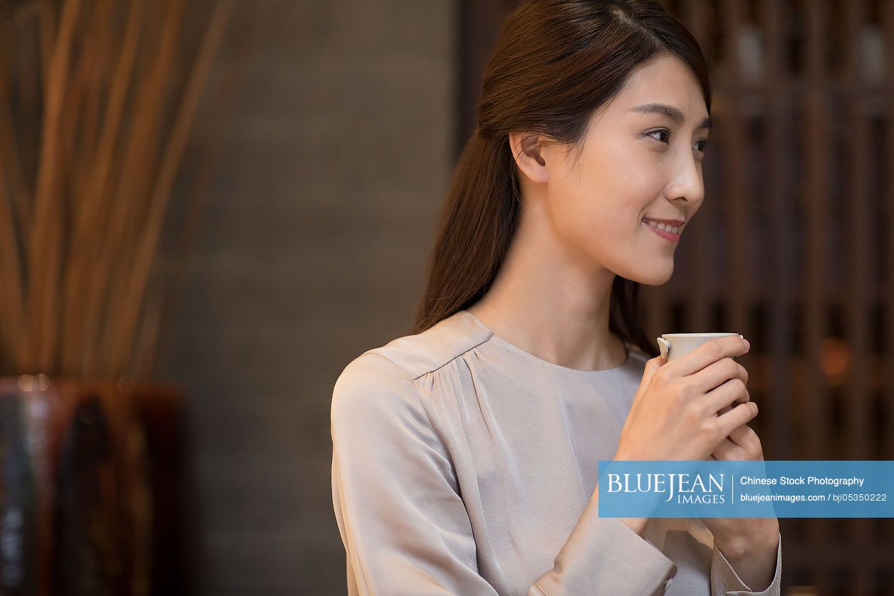 Young Chinese woman drinking tea