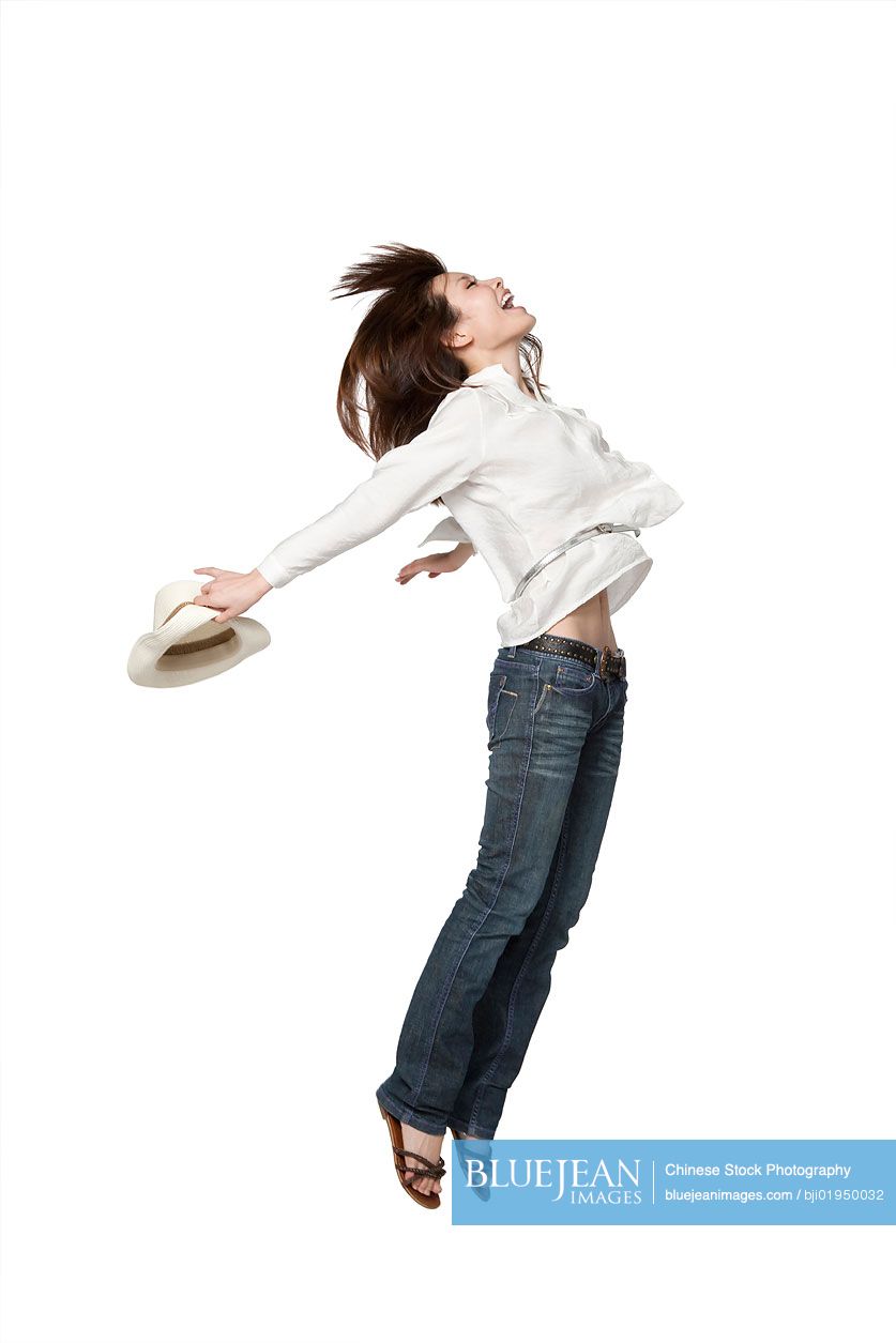 Portrait of young Chinese woman jumping