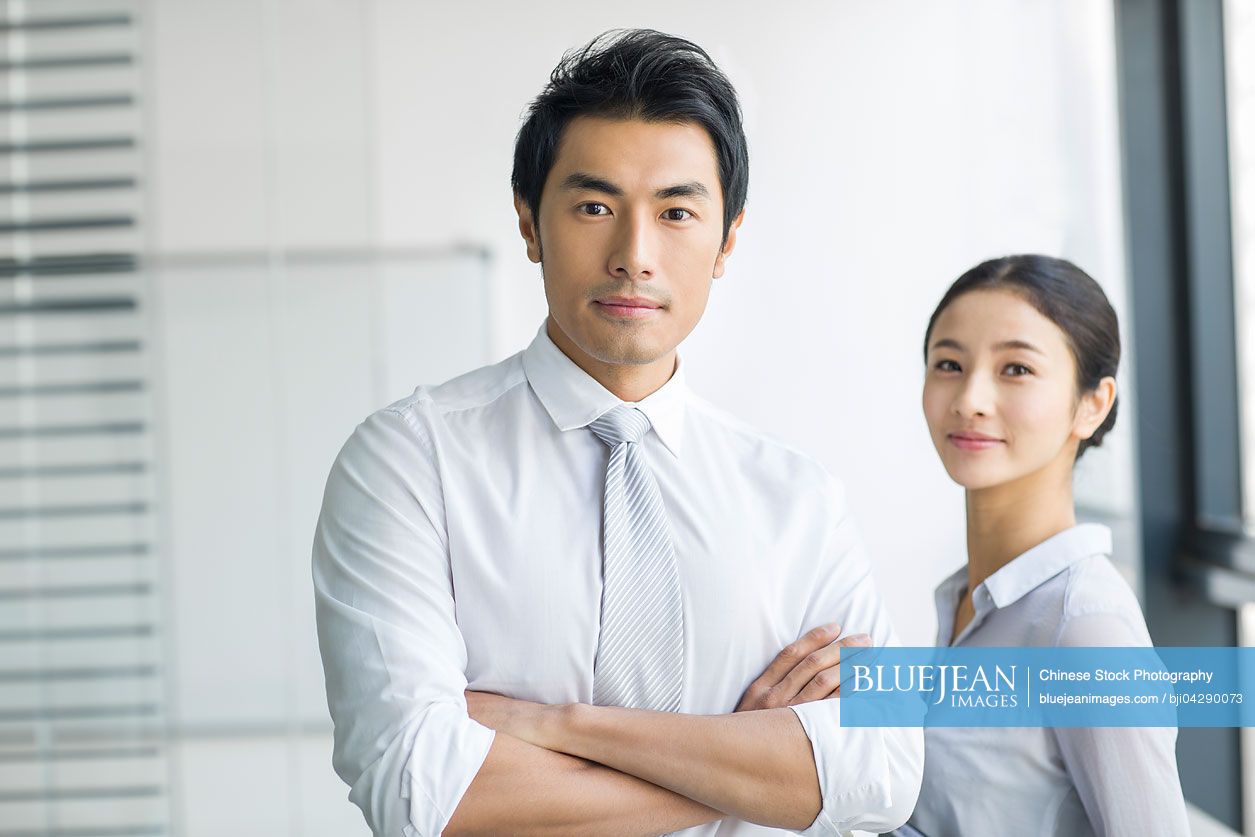 Portrait of young Chinese businessman and businesswoman