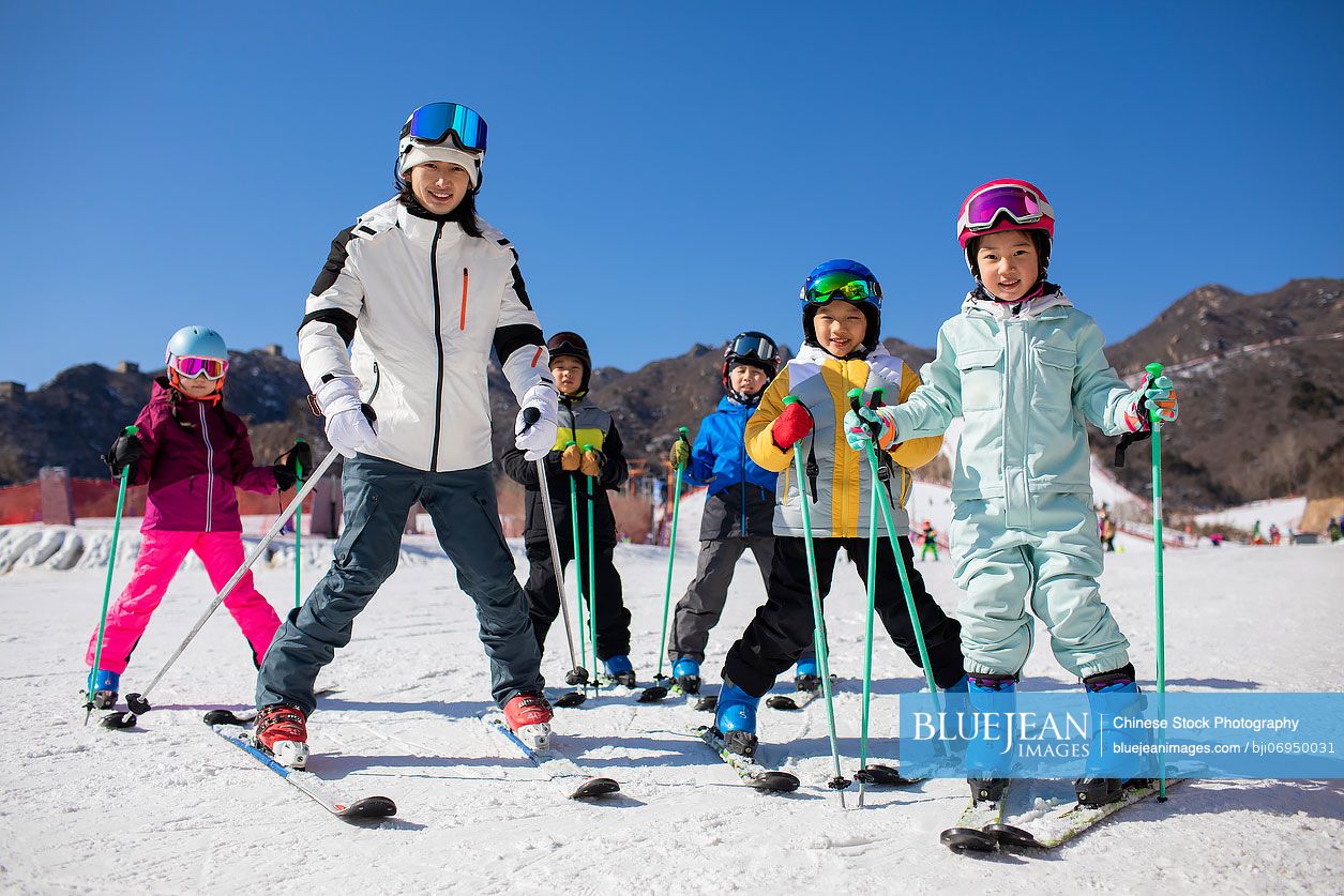 Chinese children learning how to ski with their coach