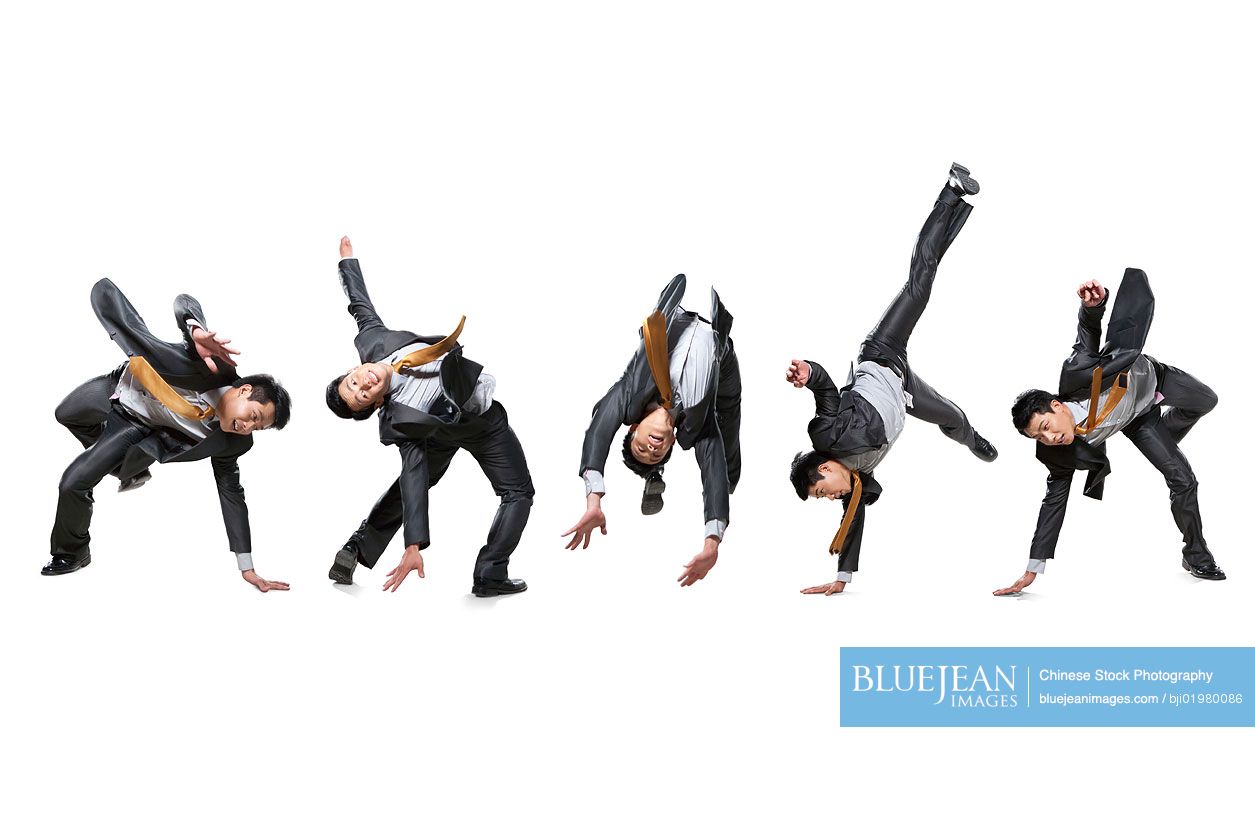 Five Chinese businessmen flipping in the air