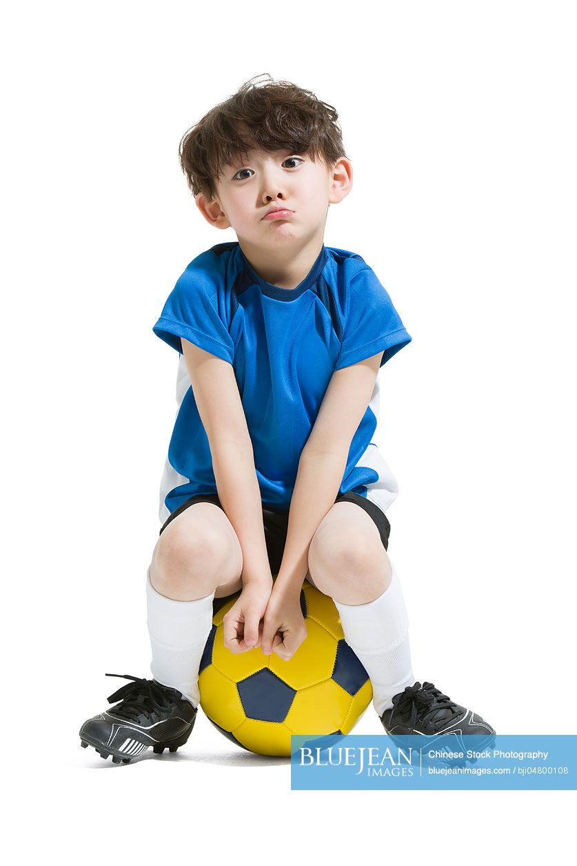 Cute Chinese boy and soccer ball