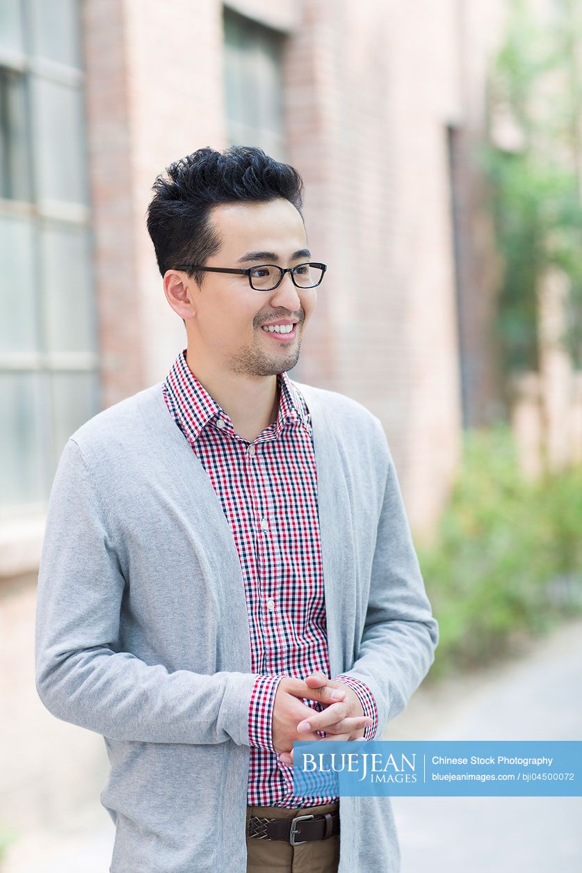 Mid adult Chinese man thinking