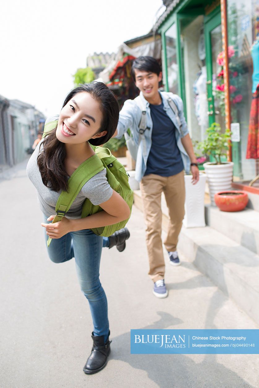 Young Chinese couple travelling in Beijing Hutong